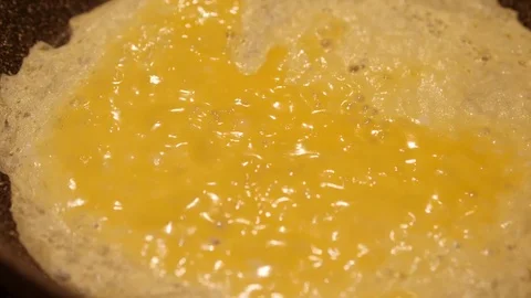 Fried eggs in a pan. Omelette from a scrambled eggs. 60 to 24fps UHD 4K Видео 74345010