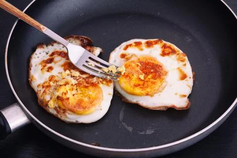 Fried eggs in a pan Stock Photos