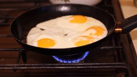 Fried eggs in a pan. Shooting at 480 frames per second. Broken egg falls into Stock Footage 75839225