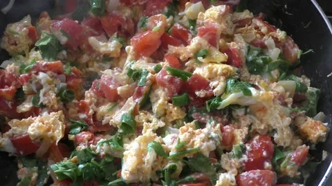 Fried eggs in a pan with vegetables Stock Footage 165892019