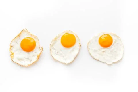 Fried eggs pattern on white background top view Stock Photos
