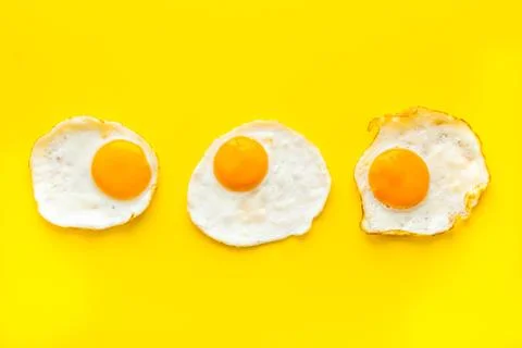 Fried eggs pattern on white table top view Stock Photos