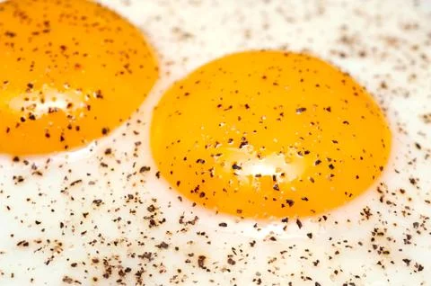 Fried eggs with pepper Stock Photos