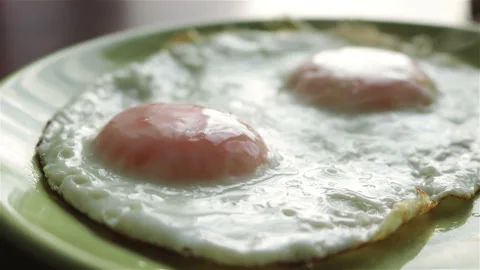 Fried eggs on plate close up Stock Footage 249372225