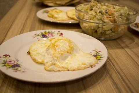 Fried eggs on a plate closeup Stock Photos