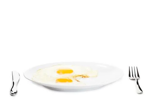 Fried eggs on a plate Stock Photos