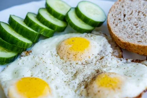 Fried eggs on plate Stock Photos