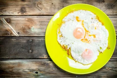 Fried eggs on a plate. Stock Photos