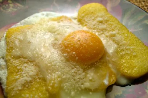 Fried eggs with polenta Stock Photos