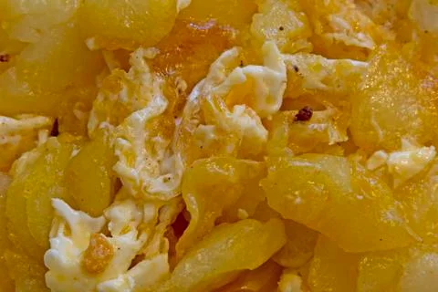 Fried eggs with potato background Stock Photos