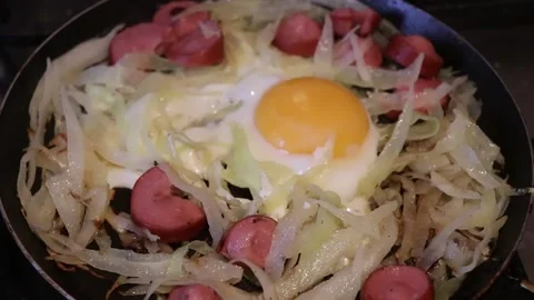 Fried eggs with sausages for breakfast Video stock 143592359