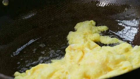 Fried eggs scooped out from hot oil. Pan-fried egg. 動画素材 341301161