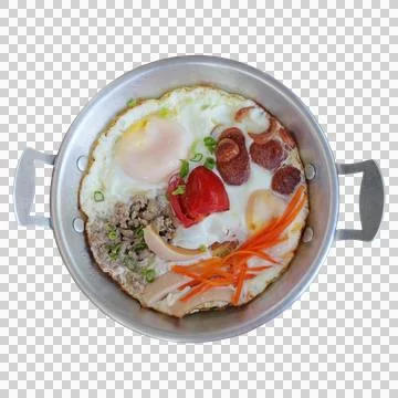 Fried eggs in small pan with various toppings and sauces (sausages, minced .. Stock Photos