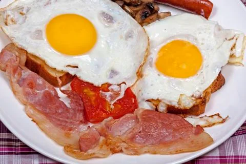 Fried Eggs on Toast with Tomato, Bacon and Mushrooms Stock Photos