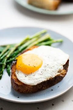 Fried eggs with toasted bread and green asparagus. Fast lunch ideas, healthy Stock Photos