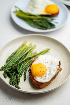 Fried eggs with toasted bread and green asparagus. Fast lunch ideas, healthy Stock Photos
