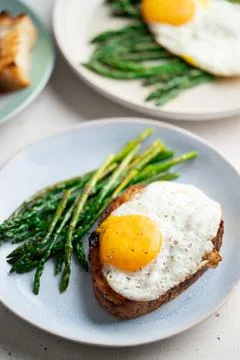 Fried eggs with toasted bread and green asparagus. Fast lunch ideas, healthy Stock Photos