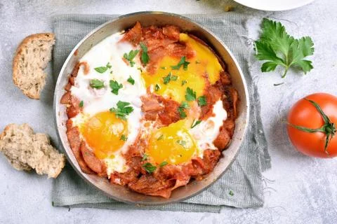 Fried eggs with tomatoes and bacon Stock Photos