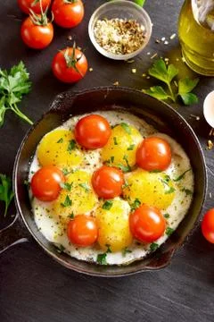 Fried eggs with tomatoes Stock Photos
