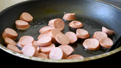 Fried eggs from two eggs with sausages on a pan Stock Footage 92131640
