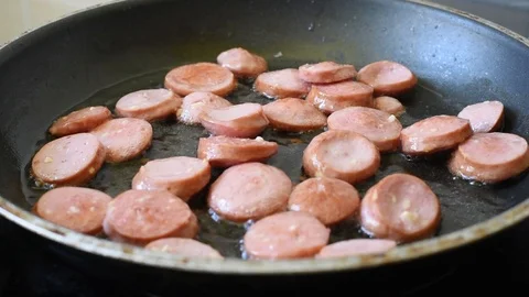 Fried eggs from two eggs with sausages on a pan Stock Footage 92131739