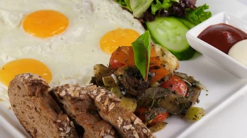 Fried eggs with vegetables and whole wheat bread, Light Breakfast Stock Footage 78528037