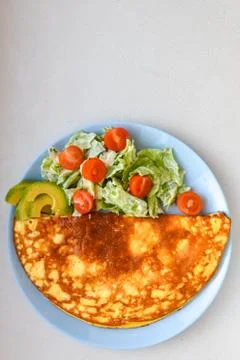 Fried eggs with vegetables. On a light background. breakfast for one Fotos Stock