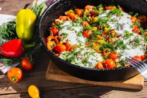 Fried eggs with vegetables in a pan Foto stock