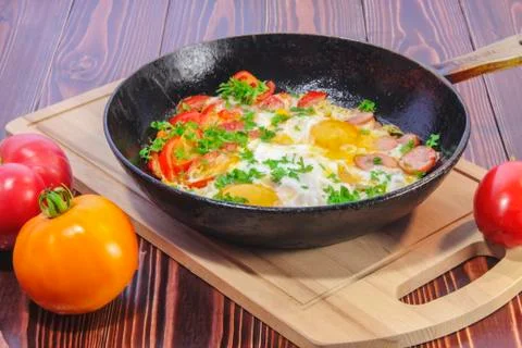 Fried eggs with vegetables Stock Photos