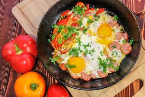 Fried eggs with vegetables Stock Photos
