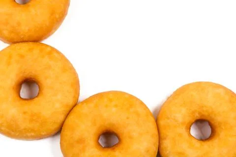 Fried equal round doughnuts in frame Stock Photos