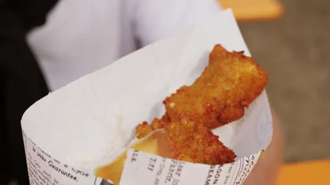 Fried fish and chips in a paper cone on festival market fodd truck. Video stock 246458359