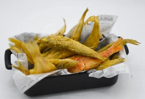 Fried fish in a box on a white background, close-up Stock Photos