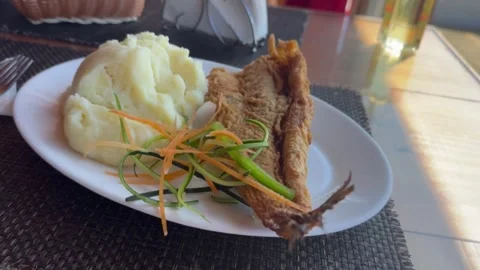 Fried fish called Merluza accompanied with mashed potatoes. Stock Footage 318981415