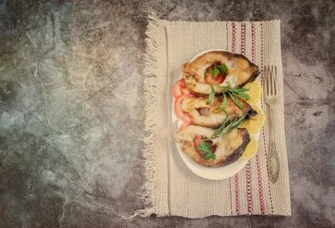 Fried fish carp on the table on a plate Stock Photos