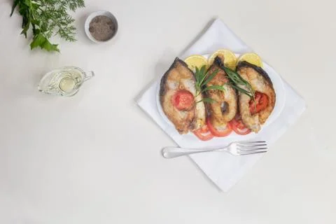 Fried fish carp on the table on a plate Foto stock