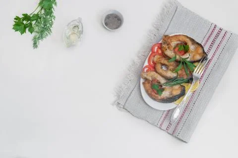 Fried fish carp on the table on a plate Stock Photos