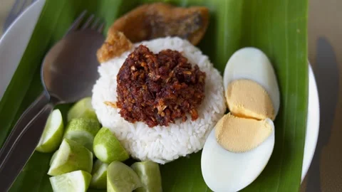 Fried fish chili paste with cucumber and boiled egg on banana leaf and stain Stock Footage 275592383