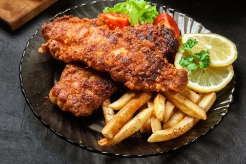 Fried fish in crispy batter with chips Stock Photos