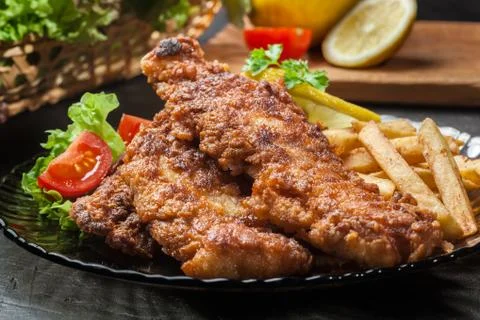 Fried fish in crispy batter with chips Stock Photos