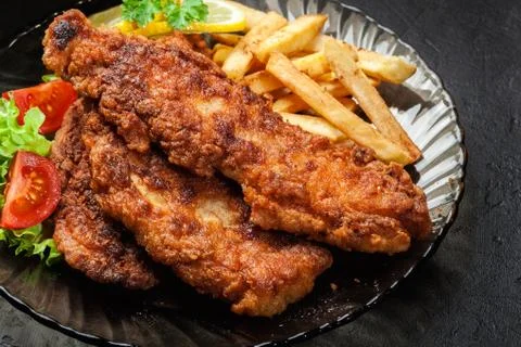 Fried fish in crispy batter with chips Stock Photos