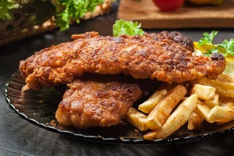 Fried fish in crispy batter with chips on a plate Stock Photos