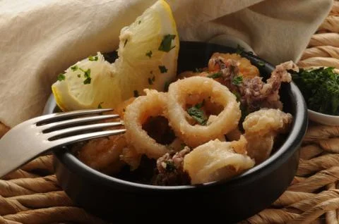 Fried fish dish with lemon slice. Stock Photos