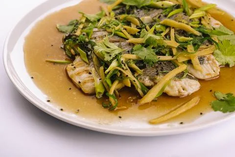 Fried fish fillet. cod with sauce and herbs Stock Photos