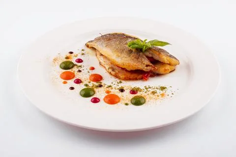 Fried fish fillet. cod with sauce and herbs Stock Photos