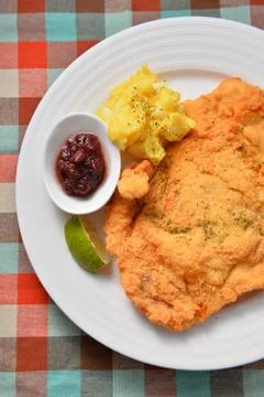 Fried fish fillet on white plate with sauces and lemon Stock Photos