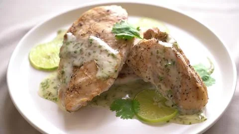 Fried fish fillets served on a plate with lettuce and cucumber Stock Photos