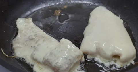 Fried fish in a frying pan Stock Footage 145186178