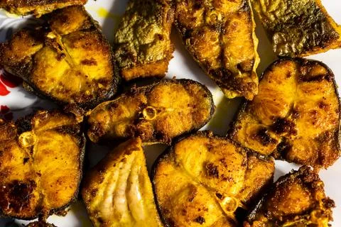 Fried fish kept at white plat at home from different angle Stockfoto's