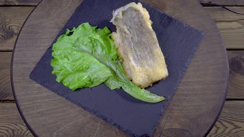 Fried fish with lemon and lettuce leaves Stock-Footage 93216337